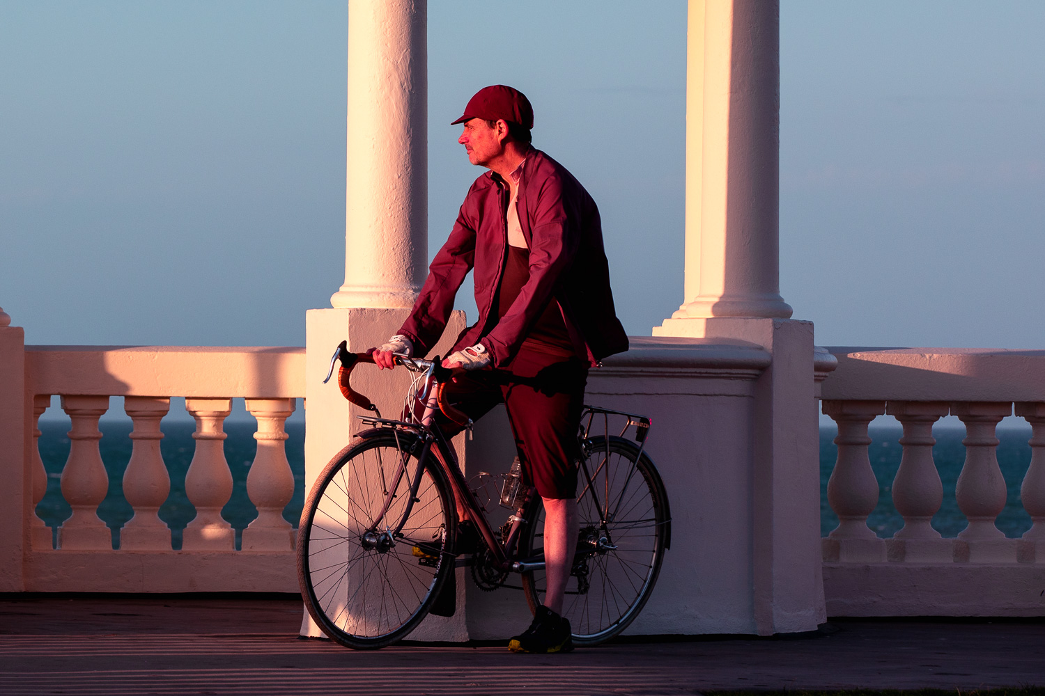 Photographer Roff Smith and classic touring bicycle photographed at the neo classical King George V Colonnade on the seafront at Bexhill on Sea East Sussex