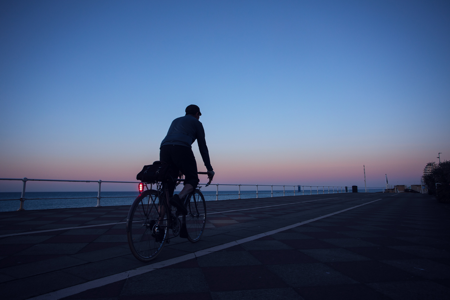 Red Sun in Morning - cyclist looking at glowing red sun rise